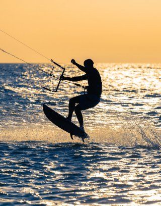 Chia | Kitesurfer hebt ab vor dem gelben Himmel der Abendsonne