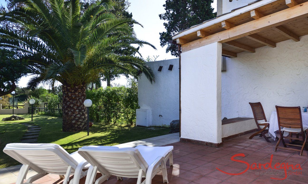 Villa Gaia | Gemütliche Sonnenliegen auf der Terrasse bieten einen Blick in den grünen Palmengarten Terrasse