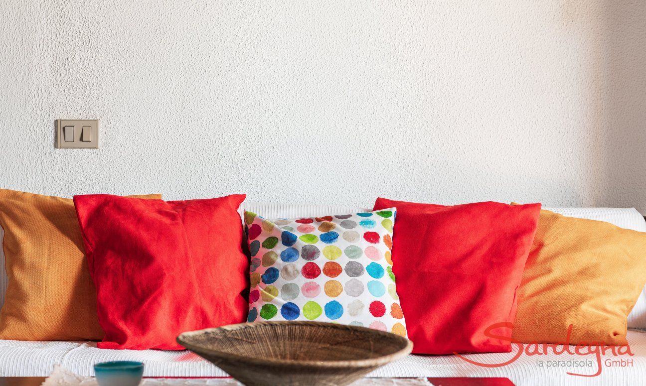 Apartment Nido 2 | Bunte Dekokissen auf dem Sofa Nido 2, Costa Rei, Südsardinien
