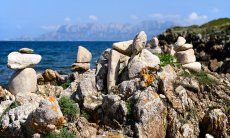 Steinformationen mit der Insel Tavolara im Hintergrund