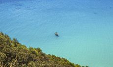 Blaues Meer mit darauf schwimmendem Motorboot, Torre delle Stelle