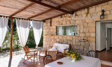 Casa Su Faru 3 | Überdachte Terrasse Su Faru 3 mit Esstisch und Sofamöbeln Überdachte Terrasse Su Faru 3 mit Esstisch und Sofamöbeln