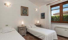 Villa Tiziana 11 | Schlafzimmer 2 mit zwei Einzelbetten, die zusammengestellt werden können und mit Blick in den Garten Hausdarstellung